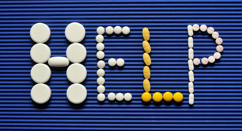 Image of the word HELP spelled out with round objects